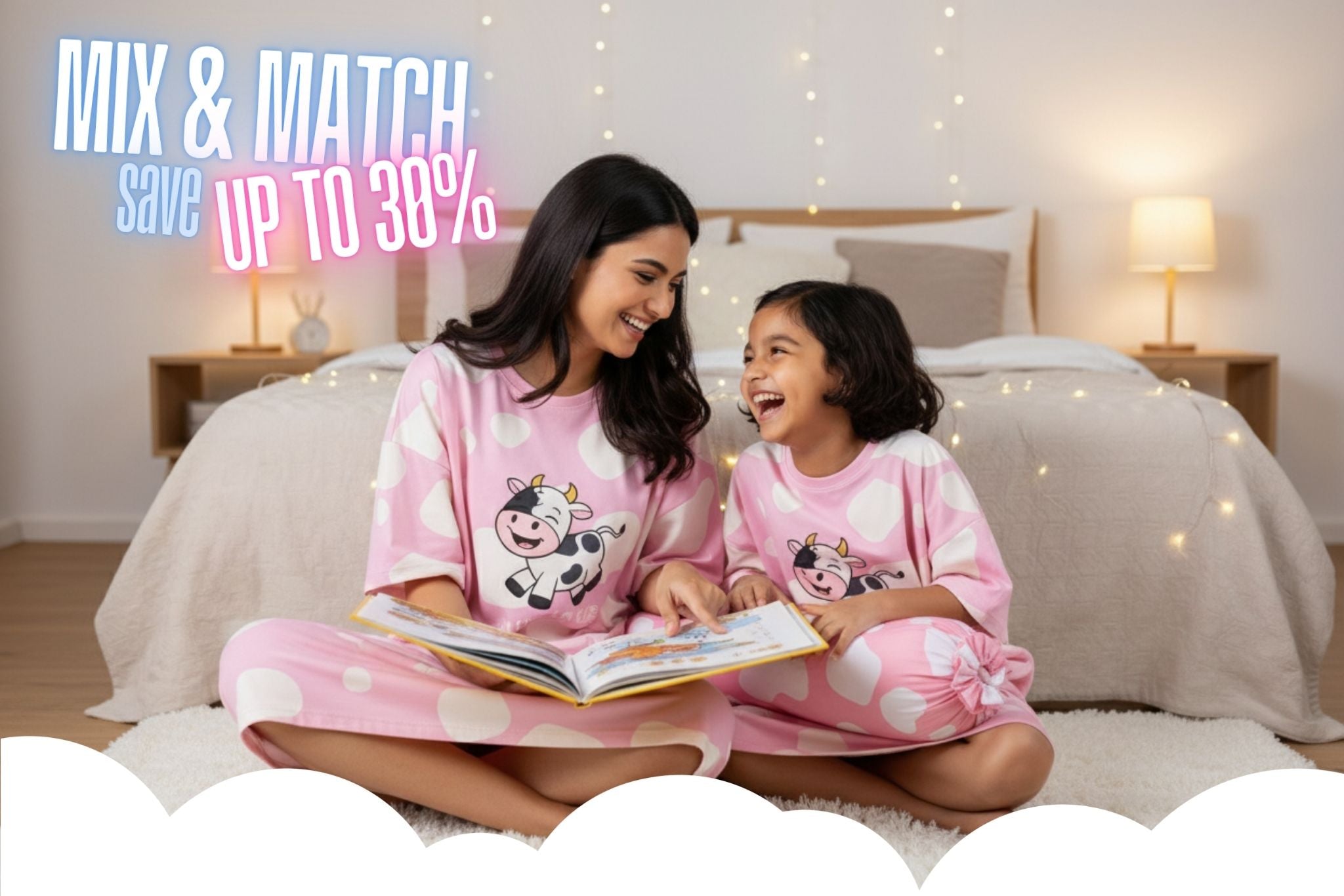 Mother and daughter laughing while reading a bedtime story, wearing matching pink cow cute sleepwear by MySleepTee. Made from our signature bamboo sleep tee fabric, widely loved as the softest sleepwear Singapore has to offer for cozy family moments. 