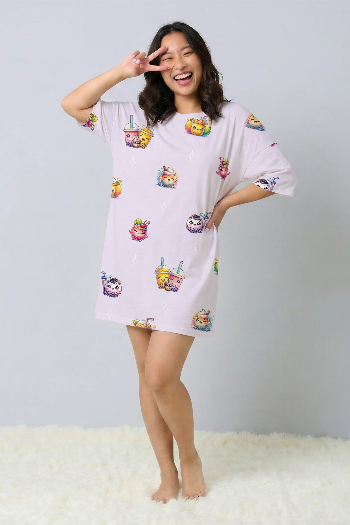 Woman laughing and making a peace sign over her eye while wearing a purple oversized bamboo sleep tee. Fun and comfortable sleepwear with a kawaii bubble tea print, designed for Singapore nights.