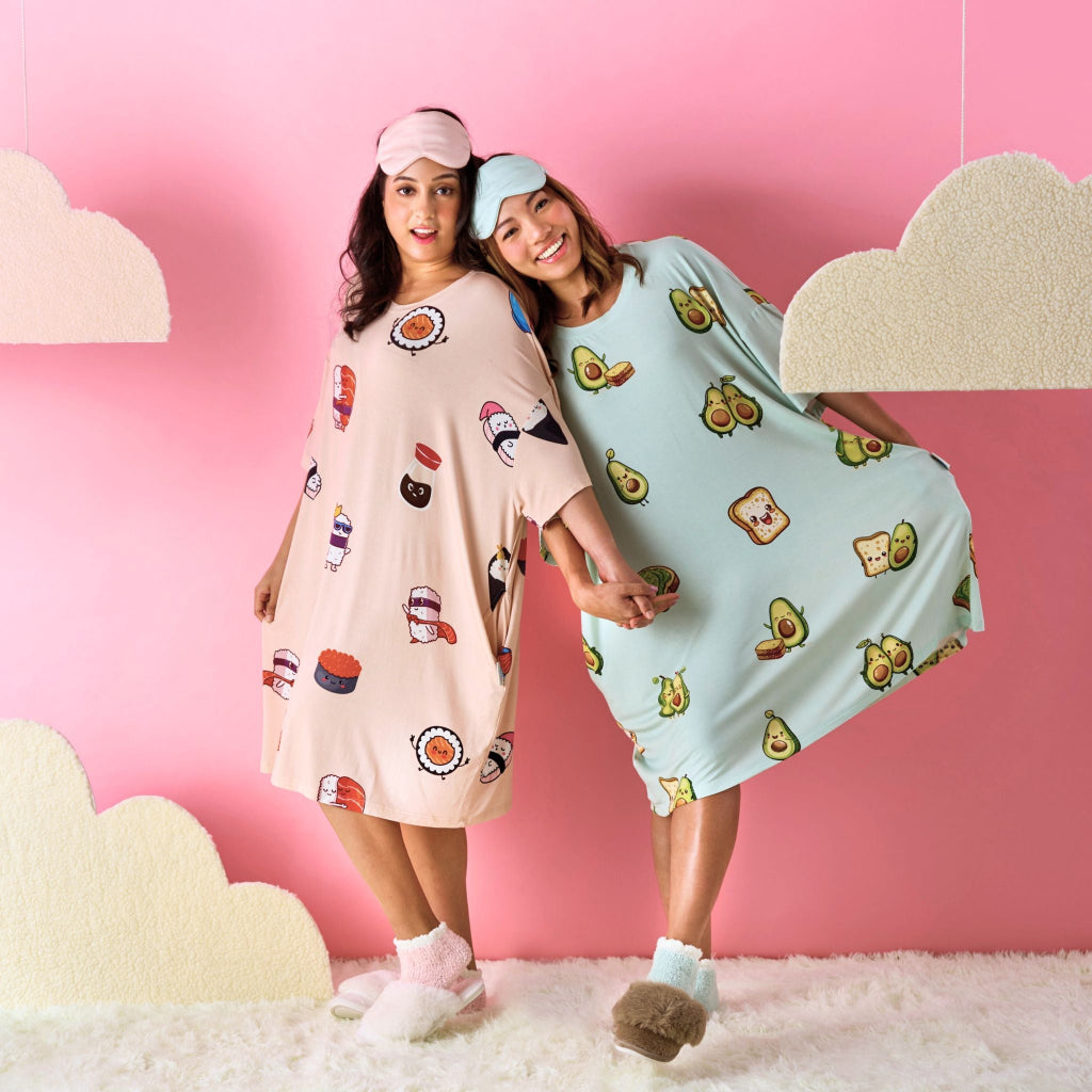 Two people wearing patterned nightgowns against a pink background with cloud decorations.